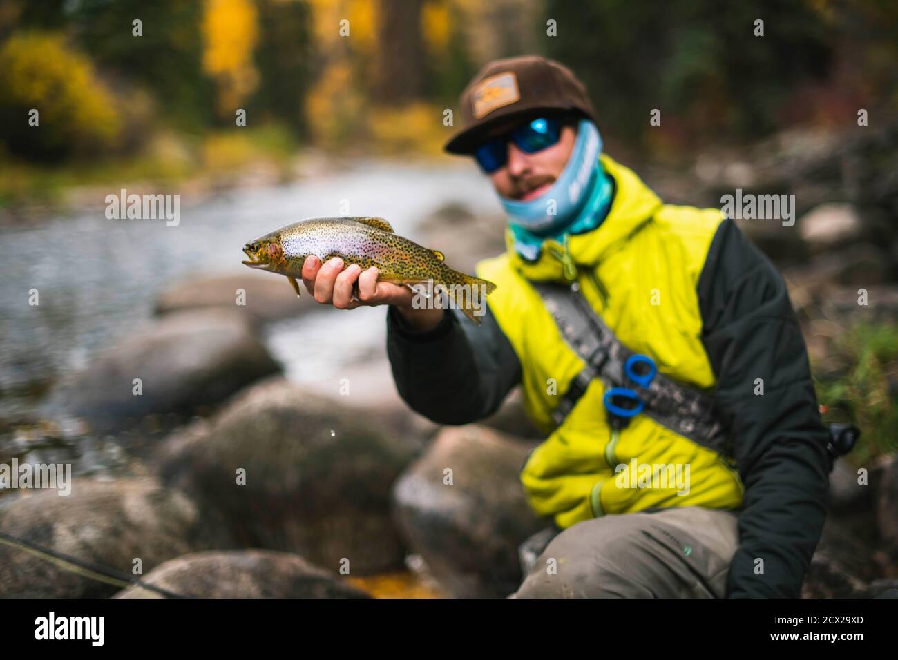 Man holding fish at Roaring Fork River Stock Photo Alamy