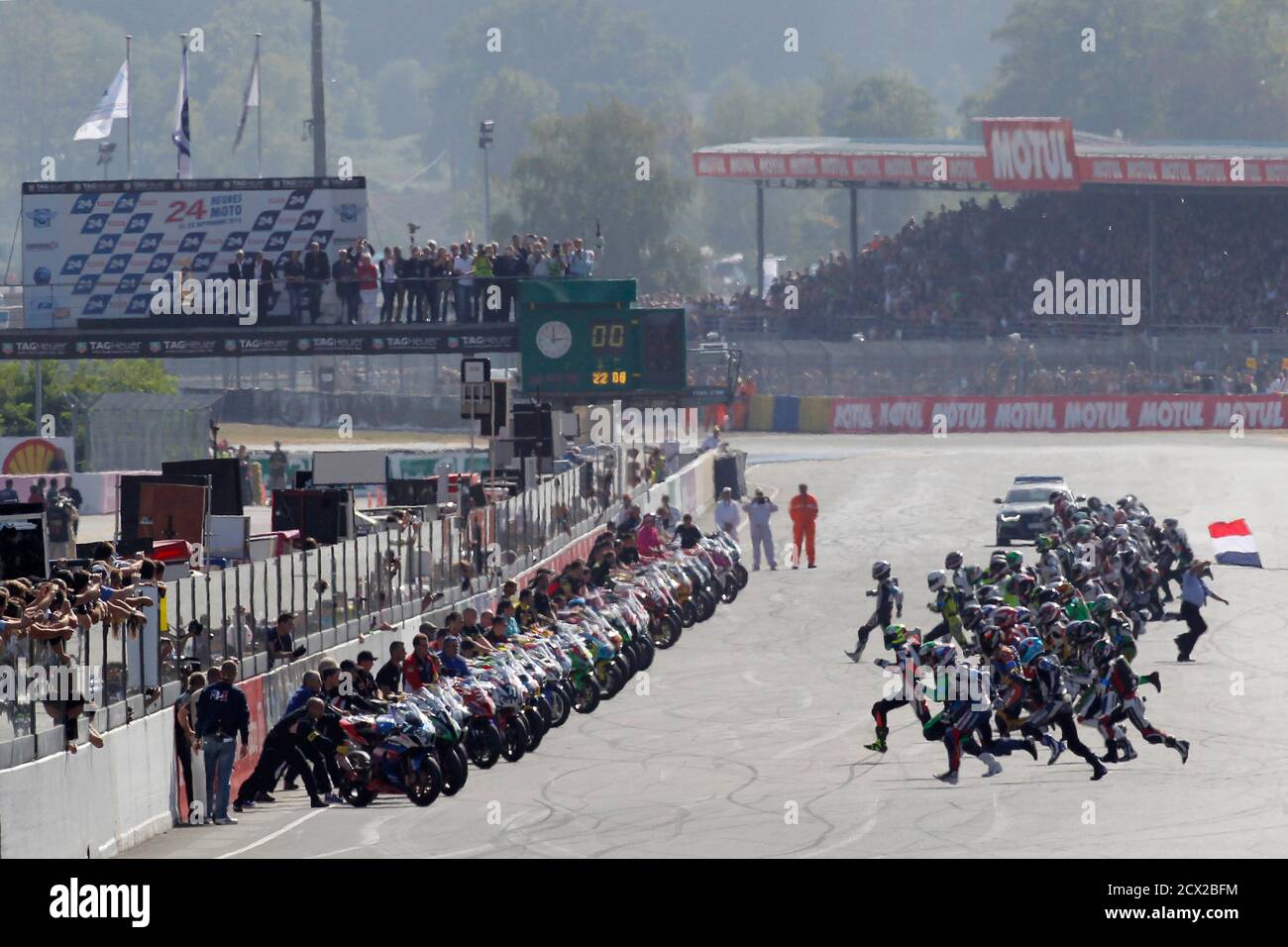 Riders run to their motorbikes at the start of the 36th Le Mans 24 Hours  motorcycling