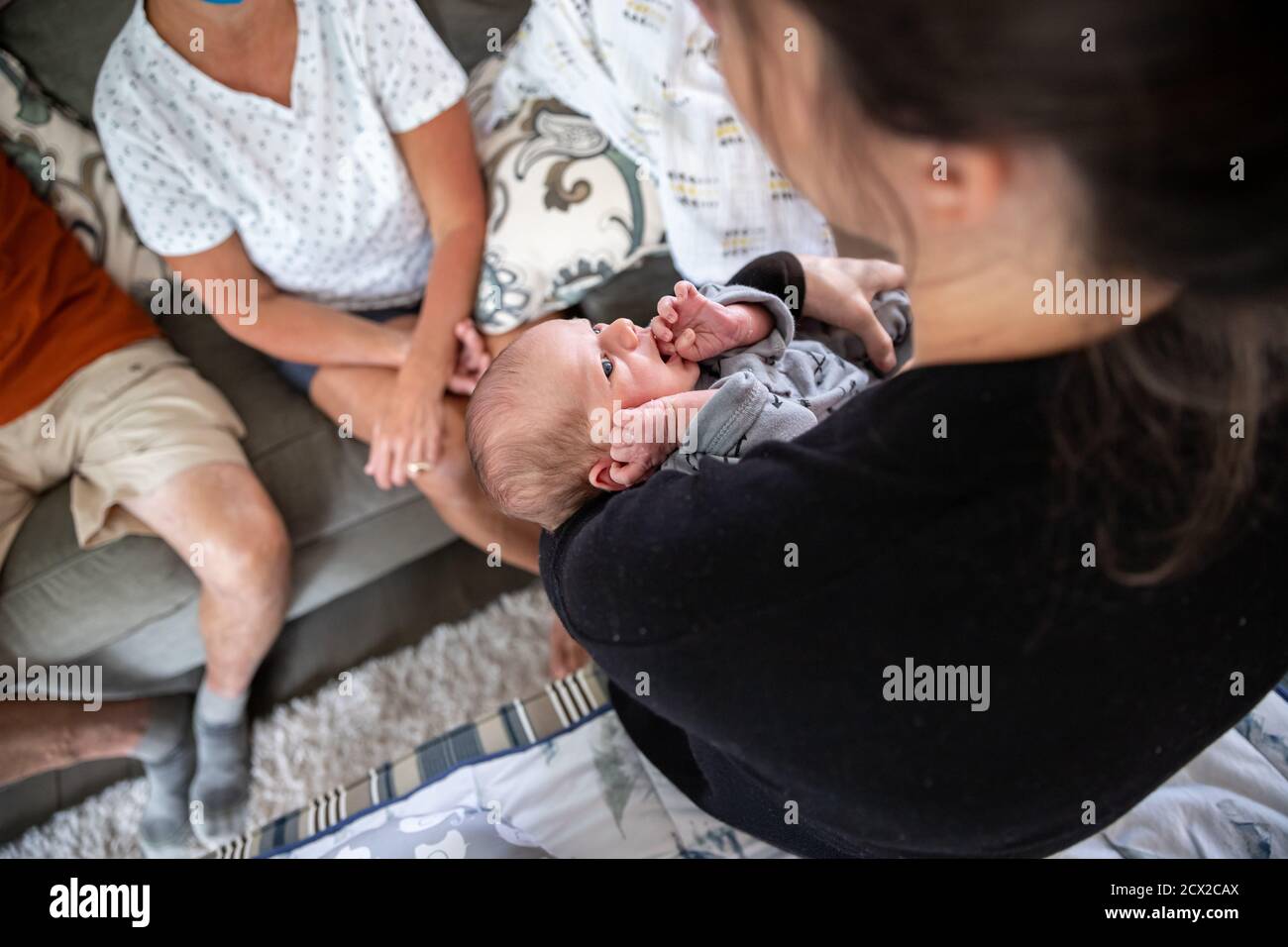 Beautiful newborn baby staring at his mother. Stock Photo