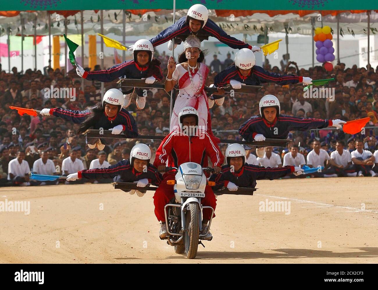 Members from the Gujarat Police perform a dare-devil show on their motorcycle during Republic Day celebrations at Himmatnagar town, about 69 km (43 miles) east from the western Indian city of Ahmedabad, January 26, 2014. India celebrates its 65th Republic Day on Sunday. REUTERS/Amit Dave (INDIA - Tags: POLITICS ANNIVERSARY SOCIETY) Stock Photo