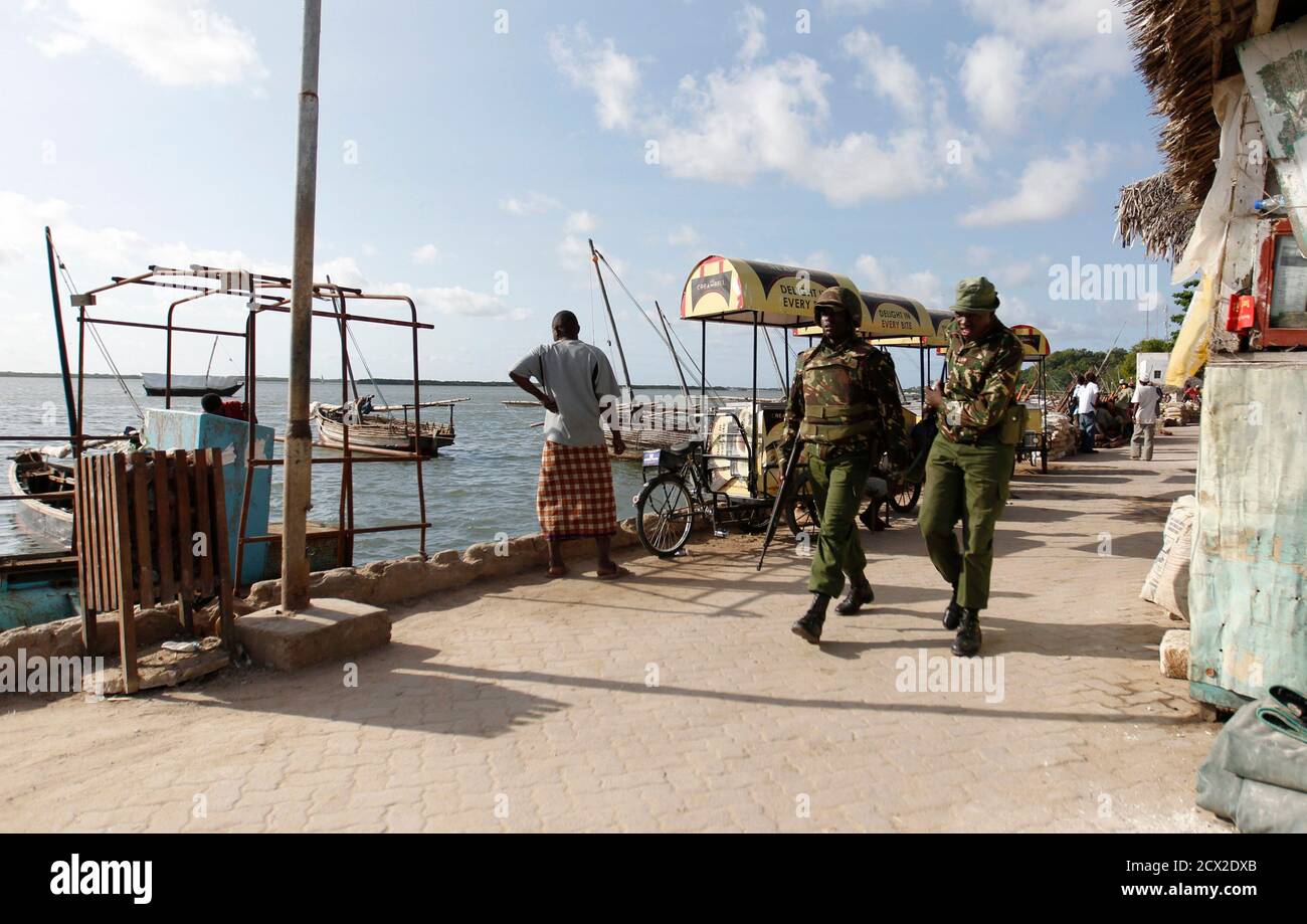 Kenya police officers patrol along the beaches of the Indian Ocean in the coastal town of Lamu, June 19, 2014. Kenya's security forces have shot dead five people suspected of involvement in attacks on the coast this week that killed about 65 people, the Interior Ministry said on Thursday. REUTERS/Thomas Mukoya (KENYA - Tags: POLITICS CIVIL UNREST CRIME LAW) Stock Photo