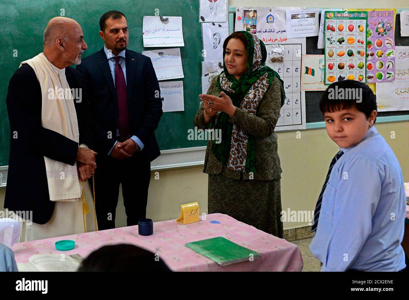 Afghan President Ashraf Ghani L Talks With A Teacher As Mirwais Karzai R Son Of Former President Hamid Karzai Looks On During His Visit To The Amani High School In Kabul September