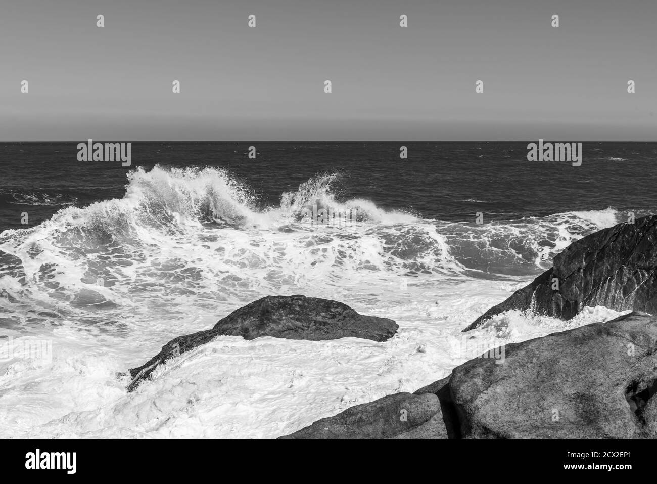 Black and white photo of wave crashing on rocks in brazilian ocean ...