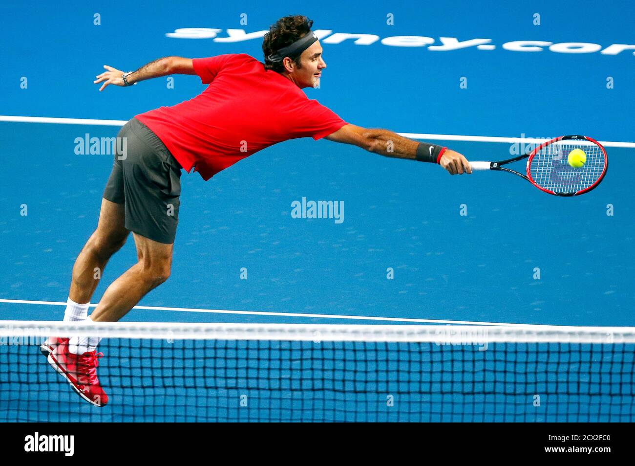 Switzerland's Roger Federer hits a shot during his match against  Australia's Lleyton Hewitt for the launch of a new format of tennis called  "Fast4" at the Sydney Entertainment Centre January 12, 2015.