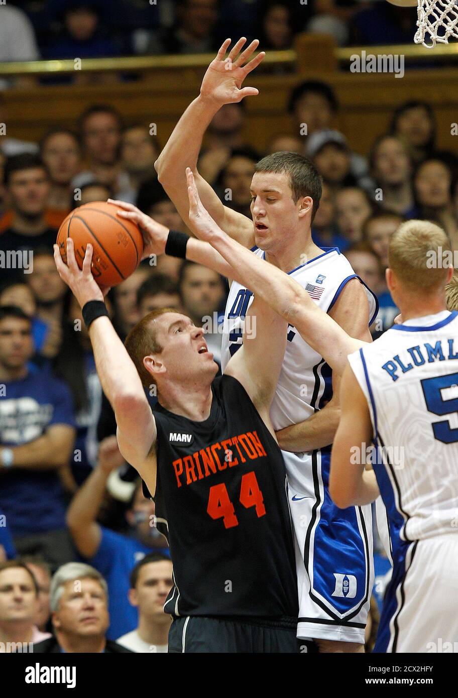 Princeton University's Brendan Connolly (L) is stopped short of the basket  by Duke University's Miles Plumlee (C) and Mason Plumlee during the first  half of their NCAA basketball game in Durham, North