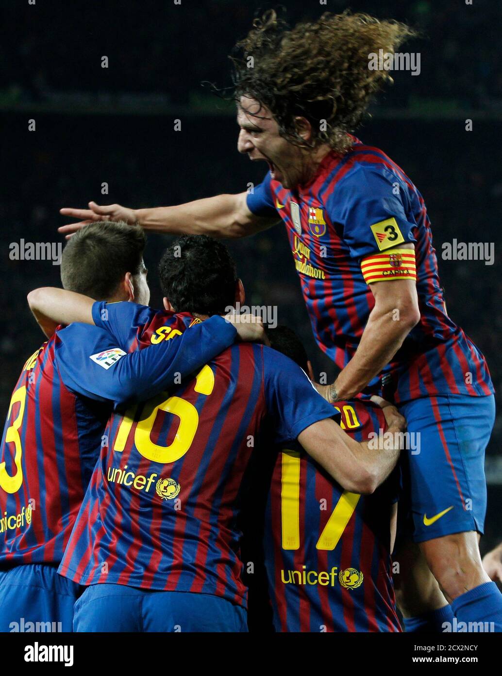 Barcelona's captain Carles Puyol (top) celebrates with teammates after Dani  Alves scored their team's second goal against Real Madrid during their  Spanish King's Cup quarter-final second leg 