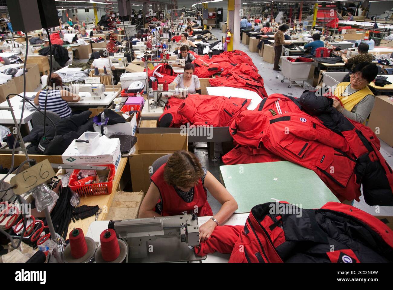 Workers piece together outerwear on the manufacturing floor of Canada  Goose's facility in Toronto January 17, 2012. Coat maker Canada Goose found  its niche by shunning the make-it-offshore phenomenon, producing its heavy