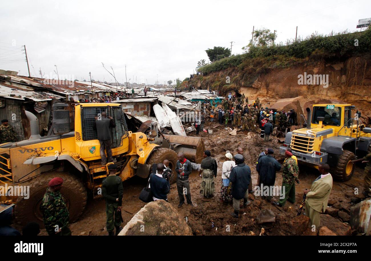 Bulldozers clear a section of the Mathare valley slum after boulders, rocks and mud tumbled down a hillside overlooking the slum, smashing into the houses and burying the occupants, in Kenya's capital Nairobi, April 4, 2012. More than four people are feared dead while scores of others are trapped as the heavy rains led to a landslide in one of Kenya's biggest slums crammed with tin and mud shanty houses. Rescue officials said the cramped nature of the slum dwellings were hindering rescue operations. REUTERS/Thomas Mukoya (KENYA - Tags: SOCIETY DISASTER ENVIRONMENT) Stock Photo