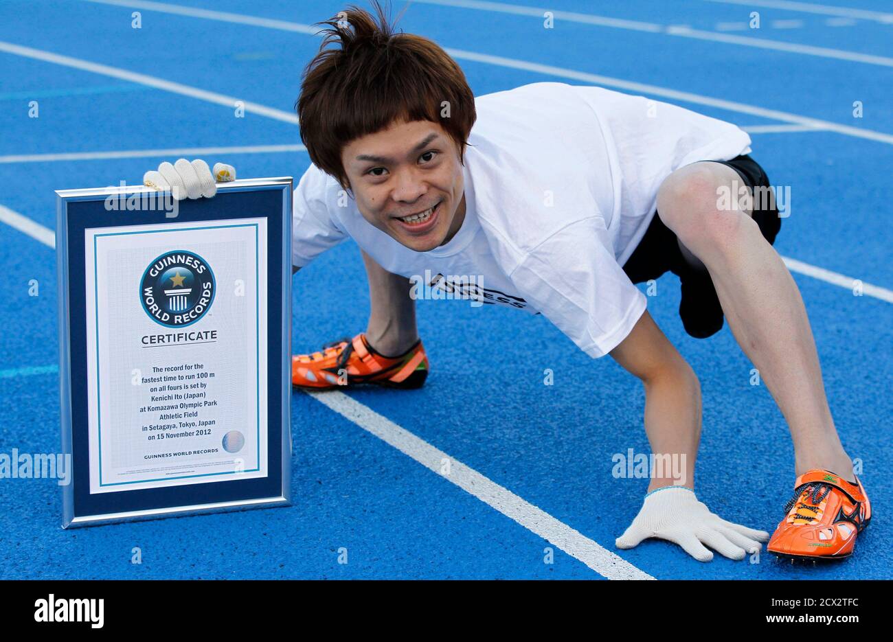 Kenichi Ito, known as the "world's fastest man on four legs", poses with  his new Guinness World Records certification for the 100-metre, in Tokyo  November 15, 2012. The 30-year-old Ito who developed