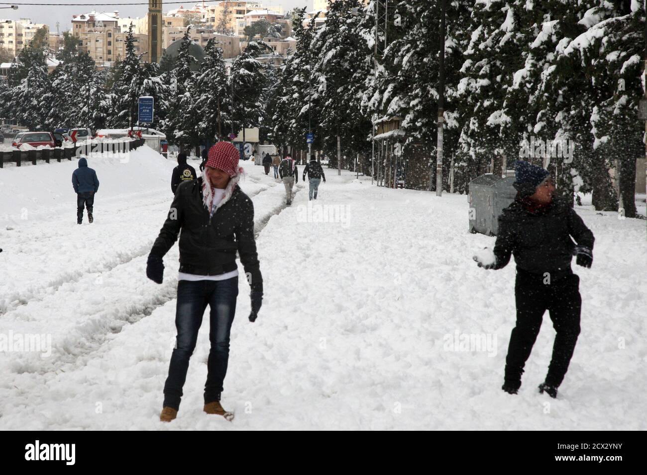 People play with snow after a heavy snowstorm in Amman December 13, 2013. A powerful winter storm sweeping the eastern Mediterranean this week is causing mayhem across the The storm, named