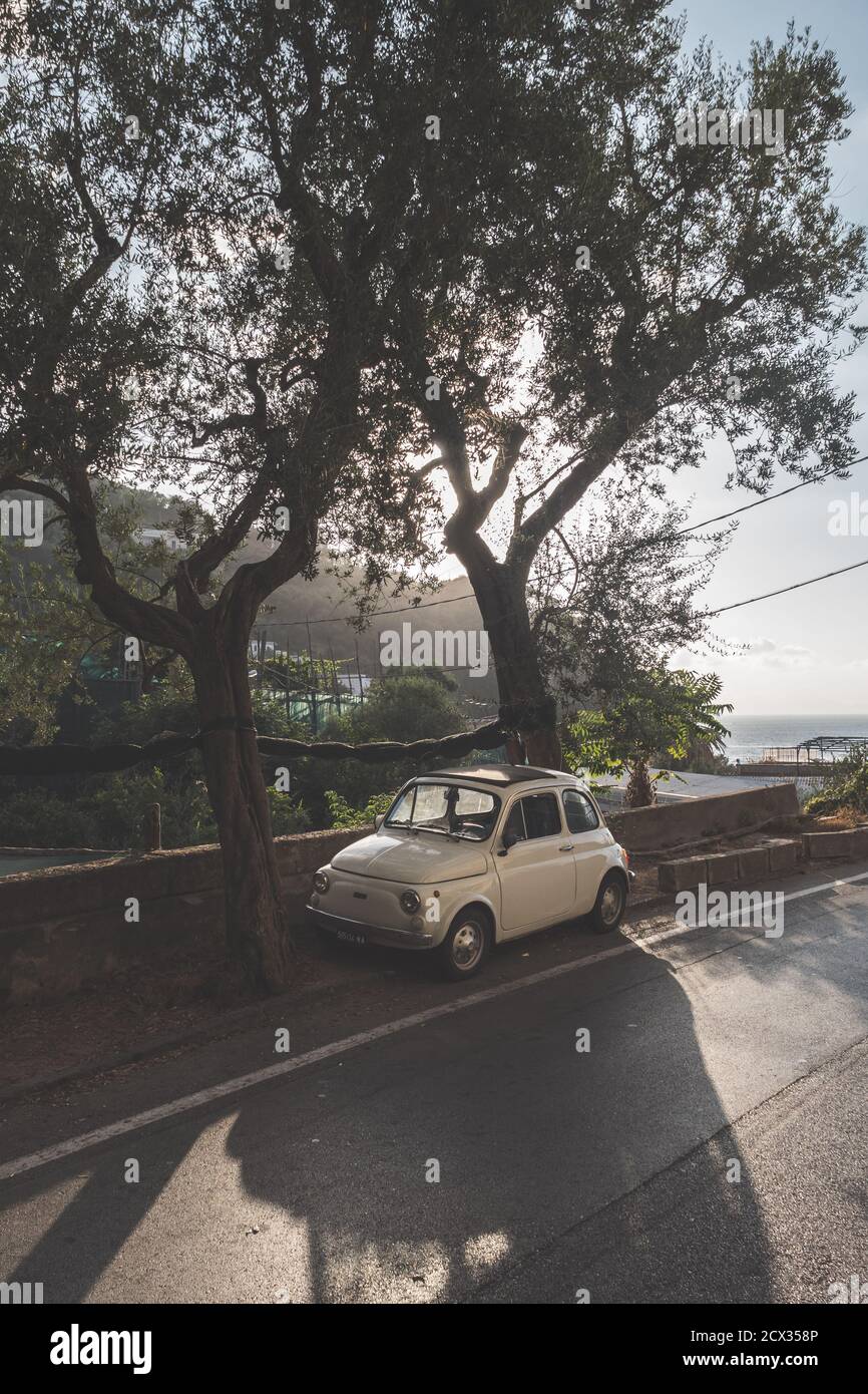 Massa Lubrense, Italy - August 23 2020: Retro, Vintage Fiat Nuova 500 Cinquecento Car in Beige or Ivory parked on the Sorrentine Coast in Summer Stock Photo