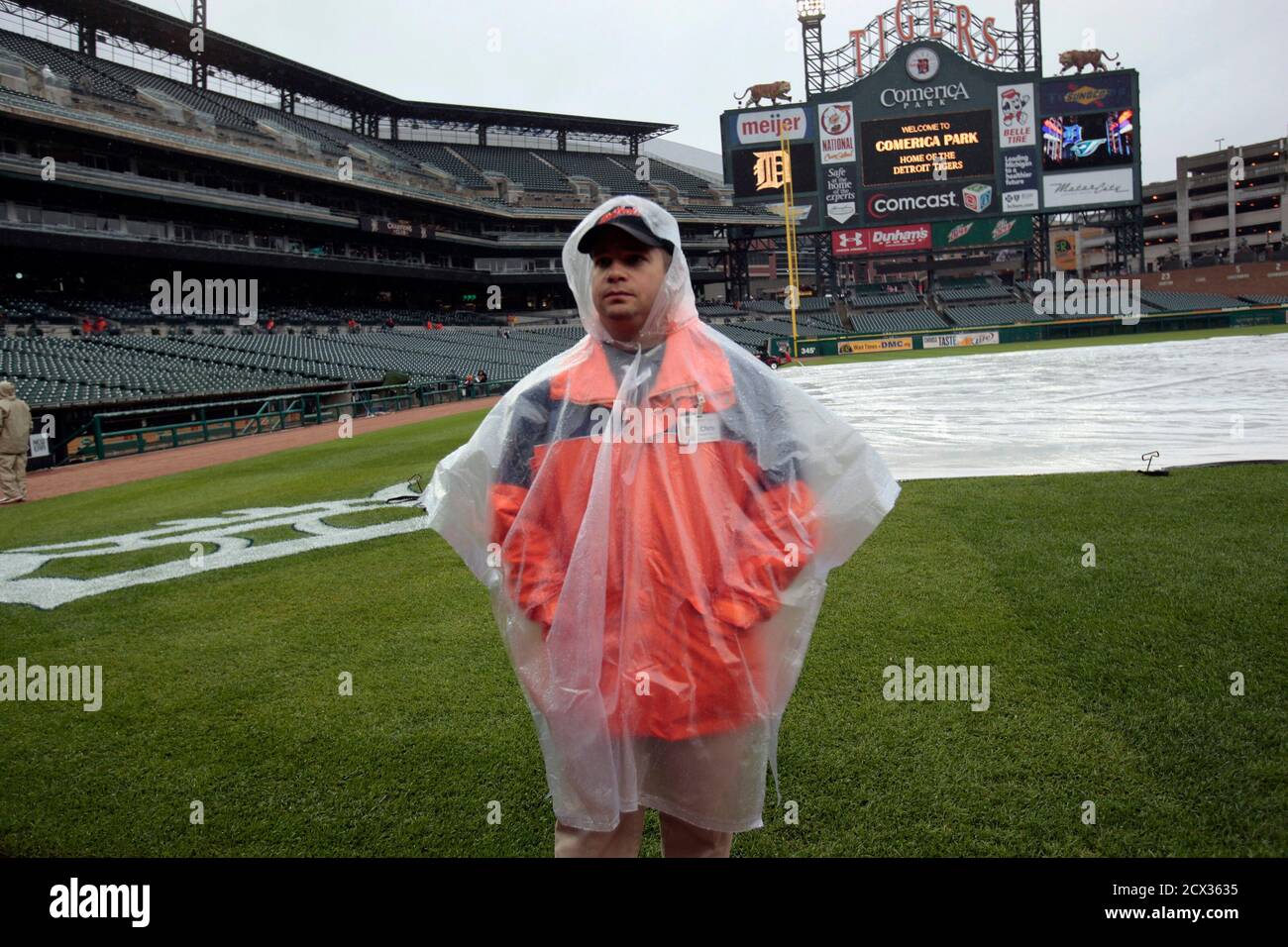 A Detroit Tigers field crew member stands on the field in the rain before the start of their MLB American League baseball game against the Toronto Blue Jays in Detroit, Michigan May 17, 2011. REUTERS/Rebecca Cook  (UNITED STATES - Tags: SPORT BASEBALL) Stock Photo