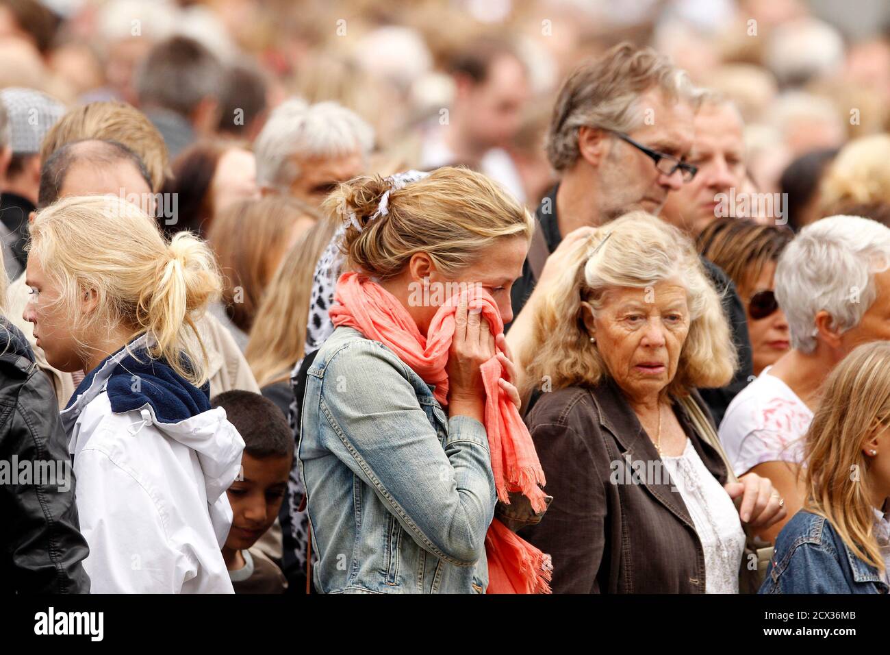 A Woman Wipes Tears From Her Eyes As She Joins People Paying Their Respects At A Sea Of Floral Tributes Placed Outside The Oslo Cathedral July 25 11 Thousands Of Norwegians Held