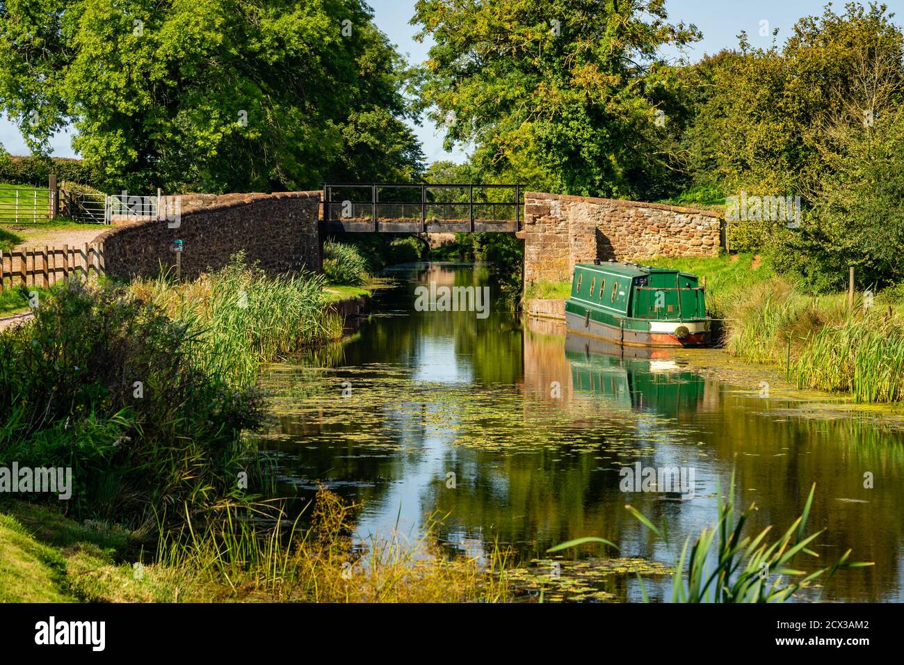 Narrow boat moored by an iron swing bridge Stock Photo