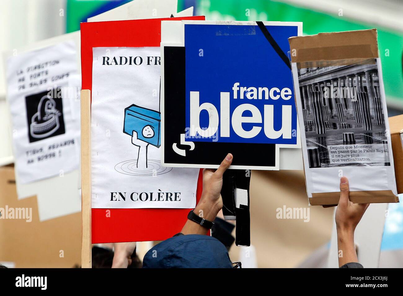 Striking Radio France employees hold placards with the name of France bleu radio  station during a demonstration in Paris April 2, 2015. Journalists and  technical staff at France's national media broadcaster have