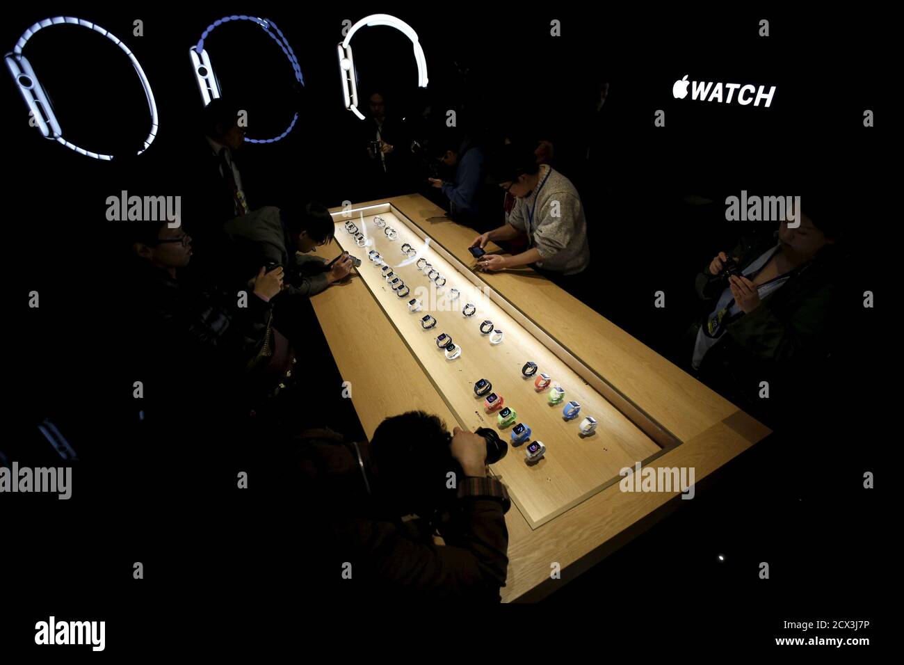 Media Crew Members Crowd Around A Display Case Containing A Range Of Apple Watches During A