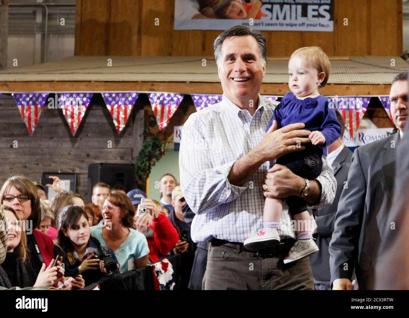 Republican presidential candidate Mitt Romney holds Madison Busch, 1, after he picked her up from her mother after a campaign event at an RV dealer in Loveland, Colorado February 7, 2012. The Colorado caucuses take place today. REUTERS/Rick Wilking (UNITED STATES - Tags: POLITICS) Stock Photo