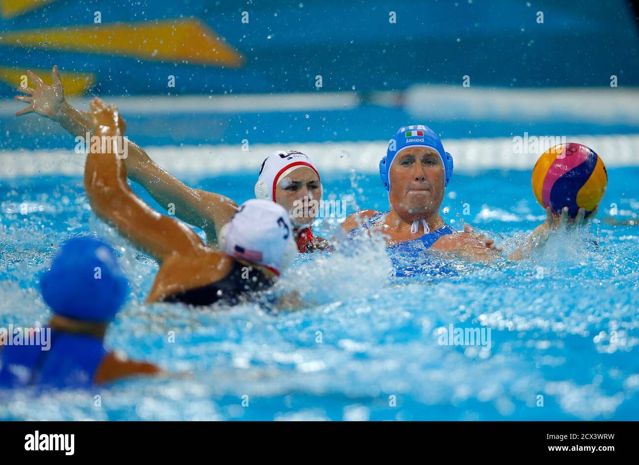 Italy's Elisa Casanova (R) is challenged by Melissa Seidemann (L) and  Jessica Steffens of U.S. during their women's water polo quarterfinal round  at the Water Polo Arena during the London 2012 Olympic