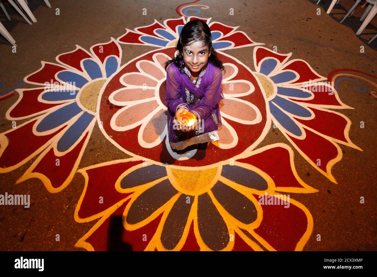 Shanaya Persad Holds A Diya Or Oil Lamp In A Street During Diwali Celebrations In Felicity