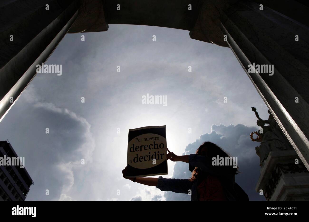 An activist holds up a poster that reads,'For our right to decide', during a demonstration in support of an 11-year-old Chilean girl, whose 32-year-old stepfather has been accused of raping her, in Mexico City July 25, 2013. The pregnancy of 'Belen', as she is known, has sparked an outcry in the Andean country, where abortion is banned under all circumstances. Abortion in Chile used to be allowed when pregnancies posed health risks, but was fully outlawed by the 1973-1990 Augusto Pinochet dictatorship, according to Human Rights Watch. REUTERS/Edgard Garrido (MEXICO - Tags: SOCIETY CIVIL UNREST Stock Photo