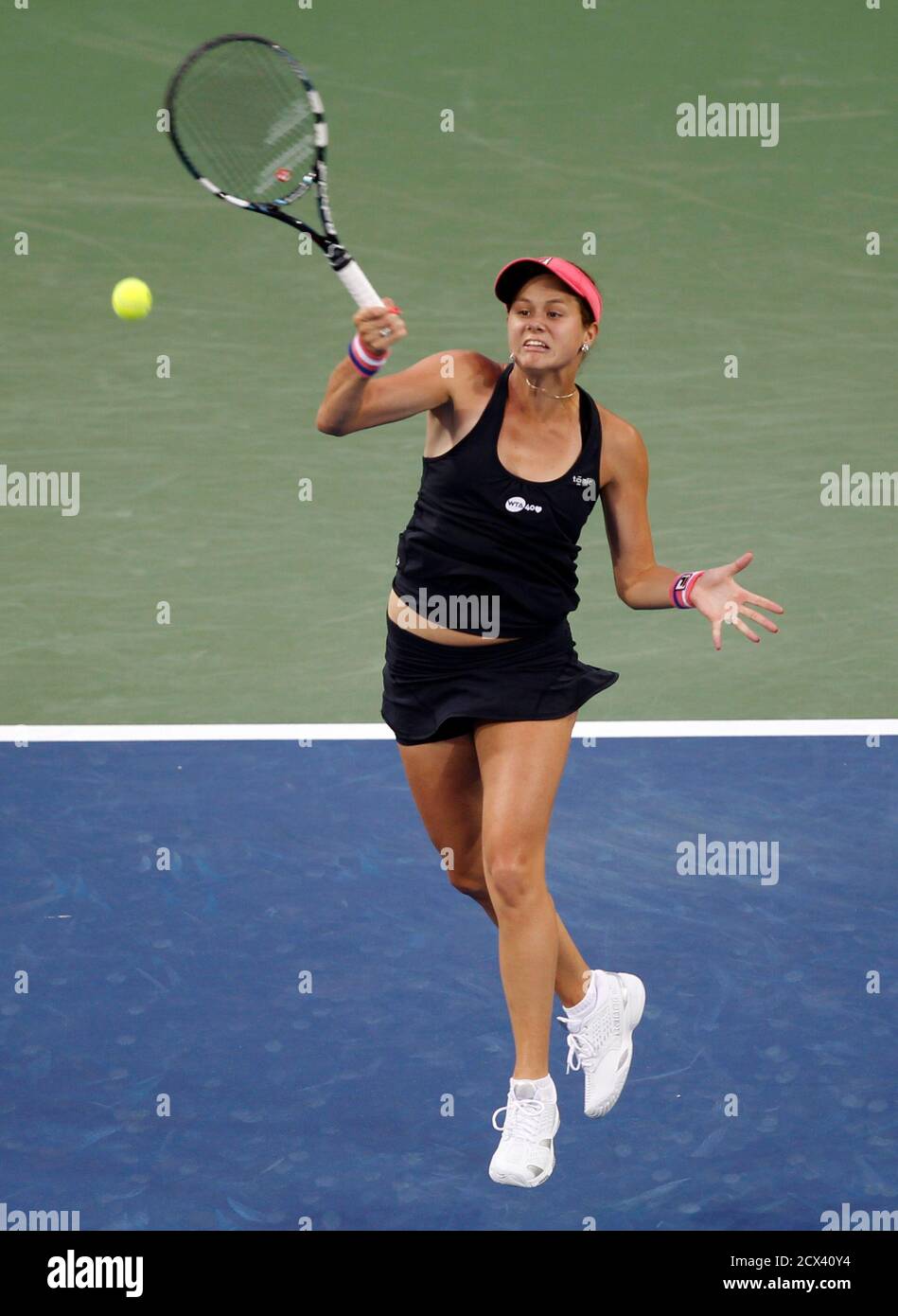 Jana Cepelova of Slovakia hits a return ball to Venus Williams of the U.S.  during their first round match at the Women's Cincinnati Open tennis  tournament in Cincinnati, Ohio August 12, 2013.