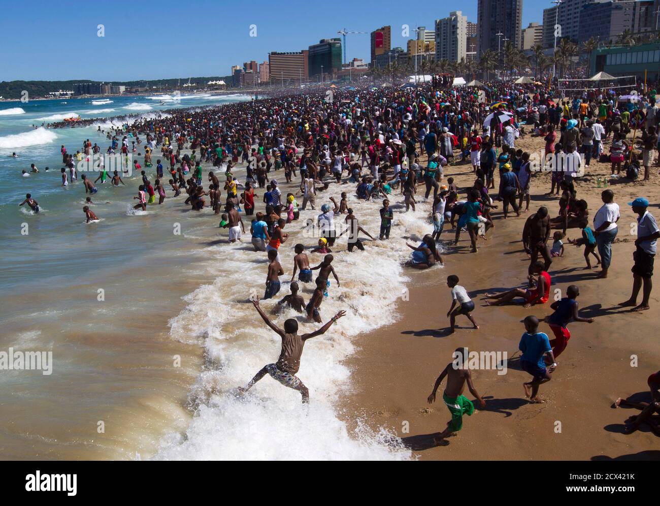 People visit the beach on New Year's Day in Durban January 1, 2014. REUTERS/Rogan Ward (SOUTH AFRICA - Tags: SOCIETY) Stock Photo