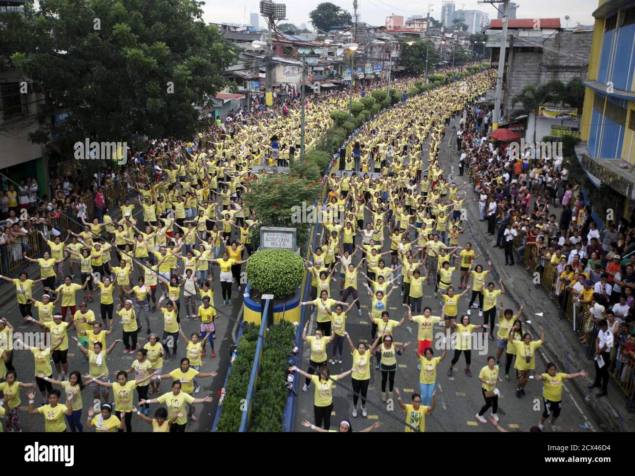 Thousands of health enthusiasts dance to high tempo music as they participate in a Guinness World Records attempt for the largest Zumba class held along the main streets of Mandaluyong city, metro Manila July 19, 2015. Mandaluyong city achieved the Guinness World Records for the largest Zumba class with an official tally of 12, 975 people simultaneously doing Zumba, overthrowing Cebu City's record of 8,232 people held in October 2014, a Guinness World Records official said. REUTERS/Lorgina Minguito Stock Photo