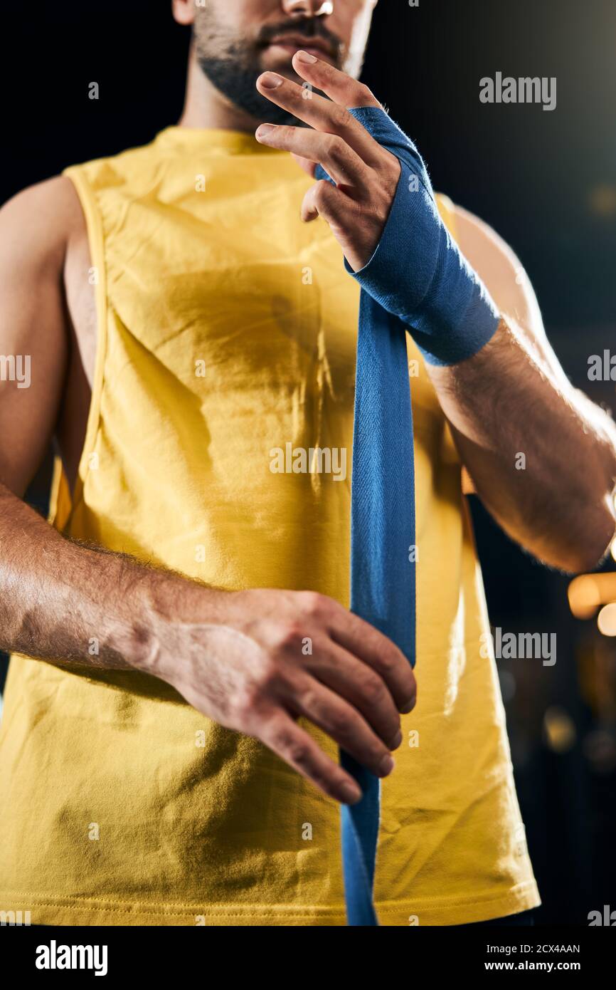 Careful boxer protecting his hand with a wrap Stock Photo - Alamy