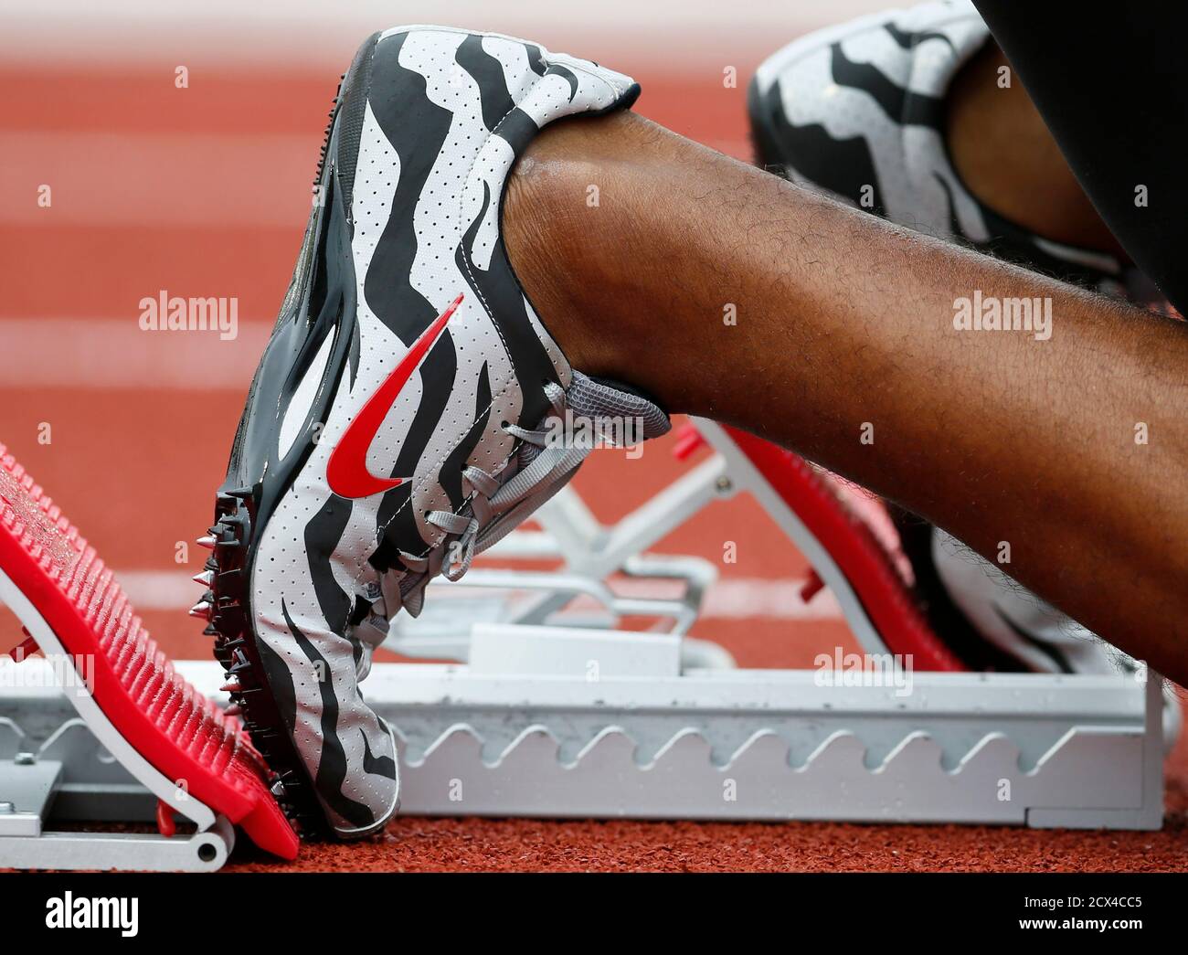 An athlete puts his Nike shoes in the starting blocks during the men's 400  meters qualifying at the U.S. Olympic athletics trials in Eugene, Oregon,  June 28, 2012. Nike Inc missed quarterly
