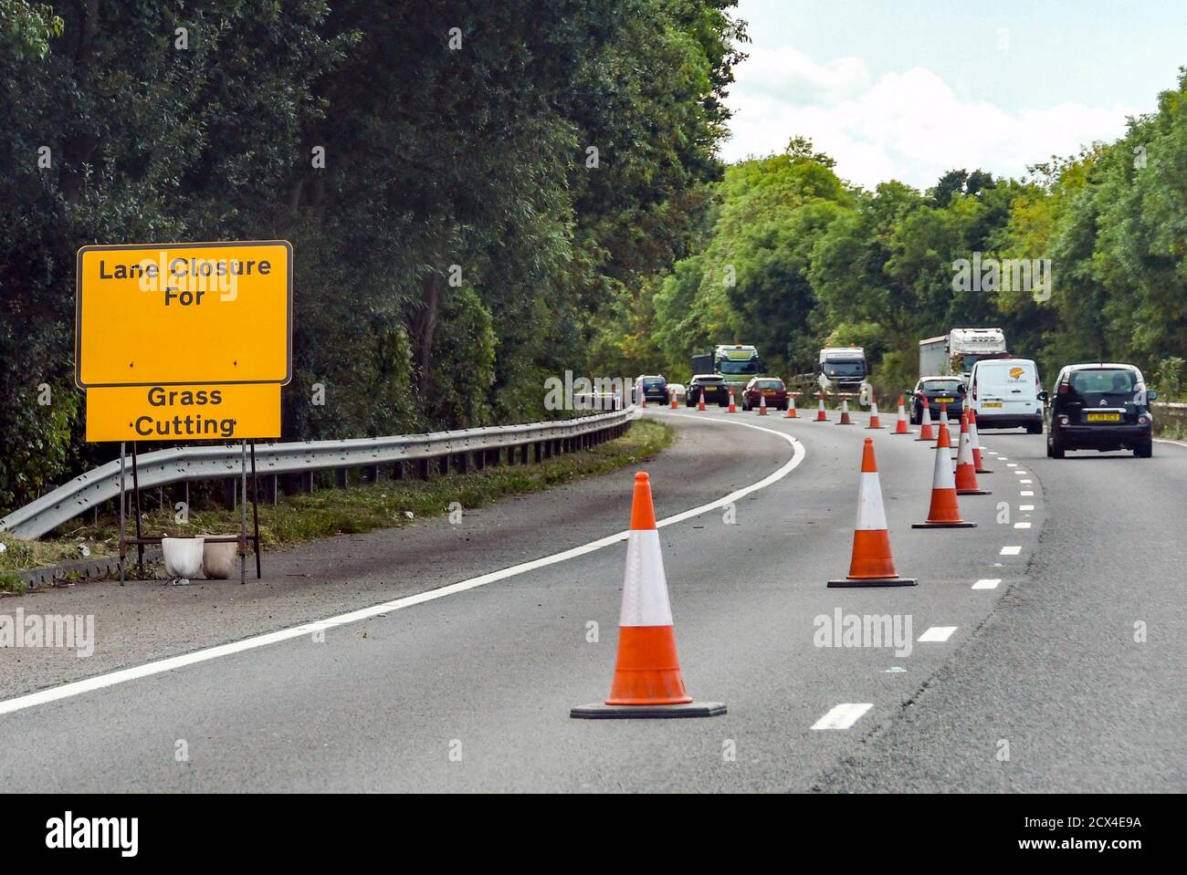 WORCESTERSHIRE, ENGLAND - SEPTEMBER 2018: Traffic cones on the M50 motorway closing a lane for grass cutting to take place Stock Photo