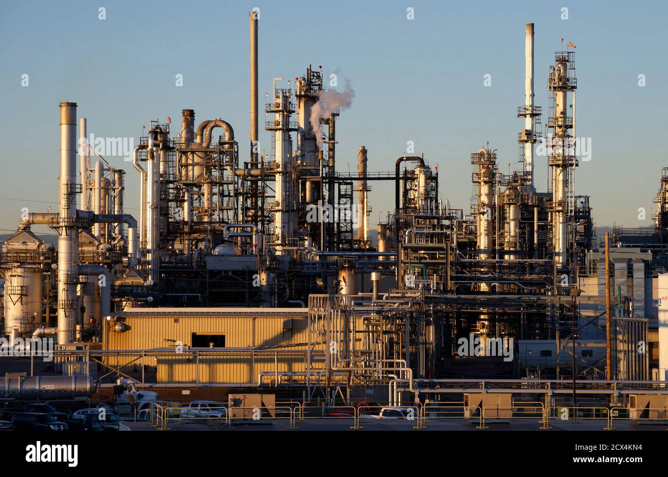 An oil refinery is seen at sunrise in Denver October 14, 2014. Brent crude fell almost 3 percent to a fresh low near $86 a barrel on Tuesday, trading at its weakest level since 2010 after the West's energy watchdog cut its estimates for oil demand this year and next. REUTERS/Rick Wilking (UNITED STATES - Tags: BUSINESS ENERGY) Stock Photo