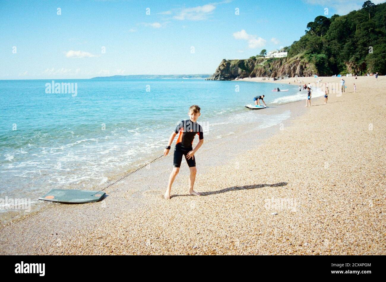 Eleven year old boy playing in the surf at Blackpool sands beach