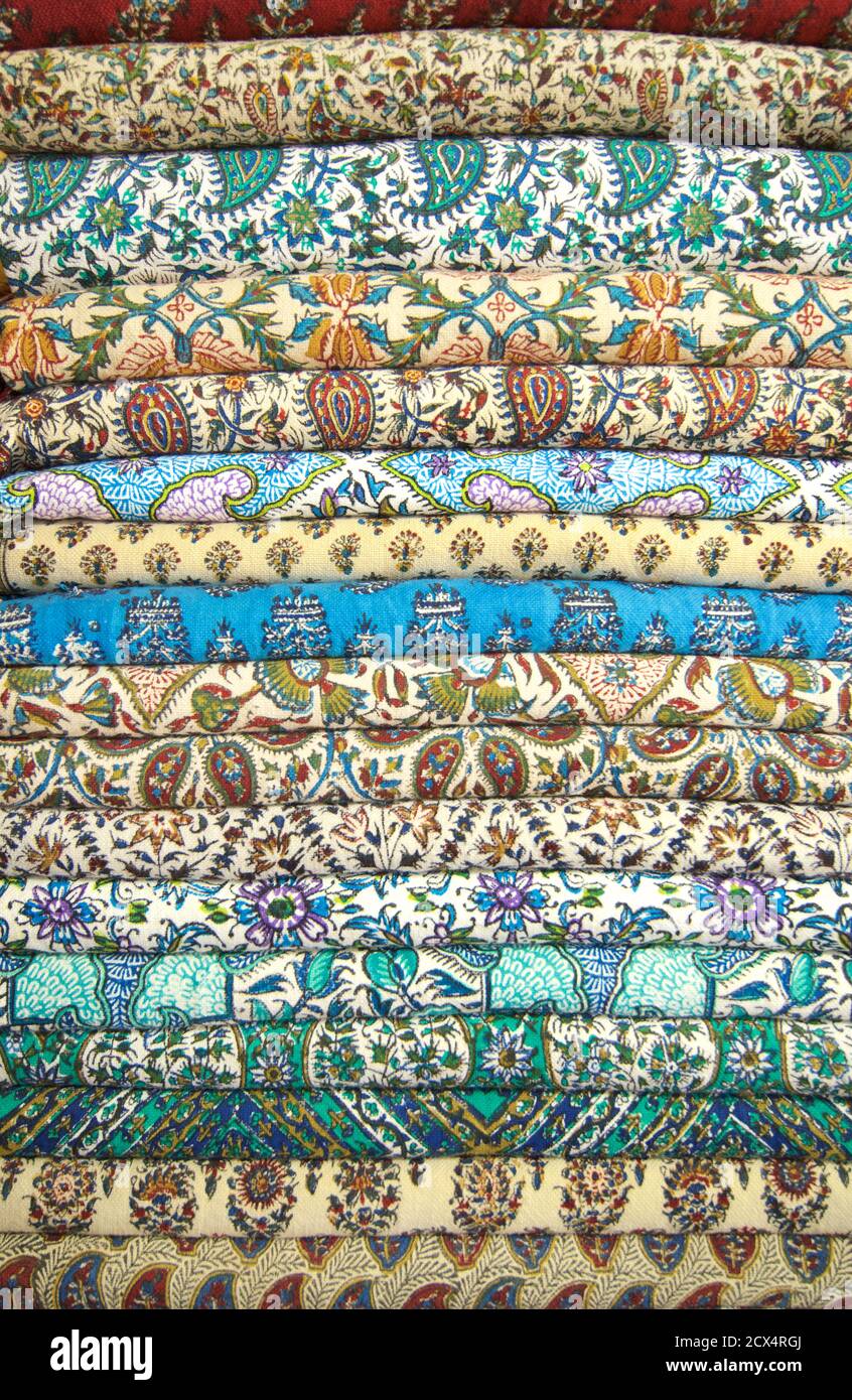 Stack of folded fabrics for sale at market, Isfahan Iran Stock Photo