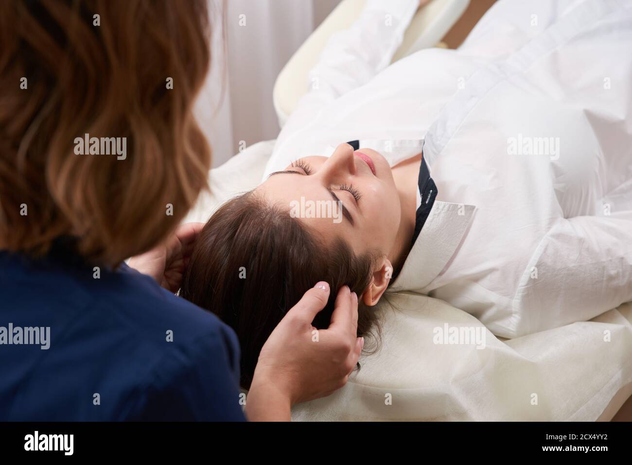 Getting Top Head Beautiful Young Woman Getting a Face and head Treatment at Beauty Salon ...