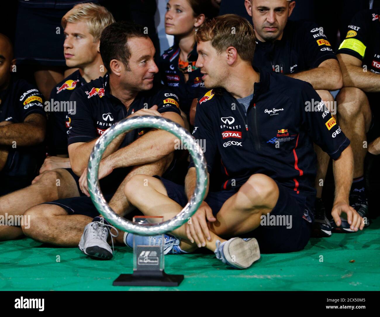 Red Bull Formula One driver Sebastian Vettel of Germany (R) and Ole Schack,  his front end engineer, pose for a team photo after the Singapore F1 Grand  Prix at the Marina Bay