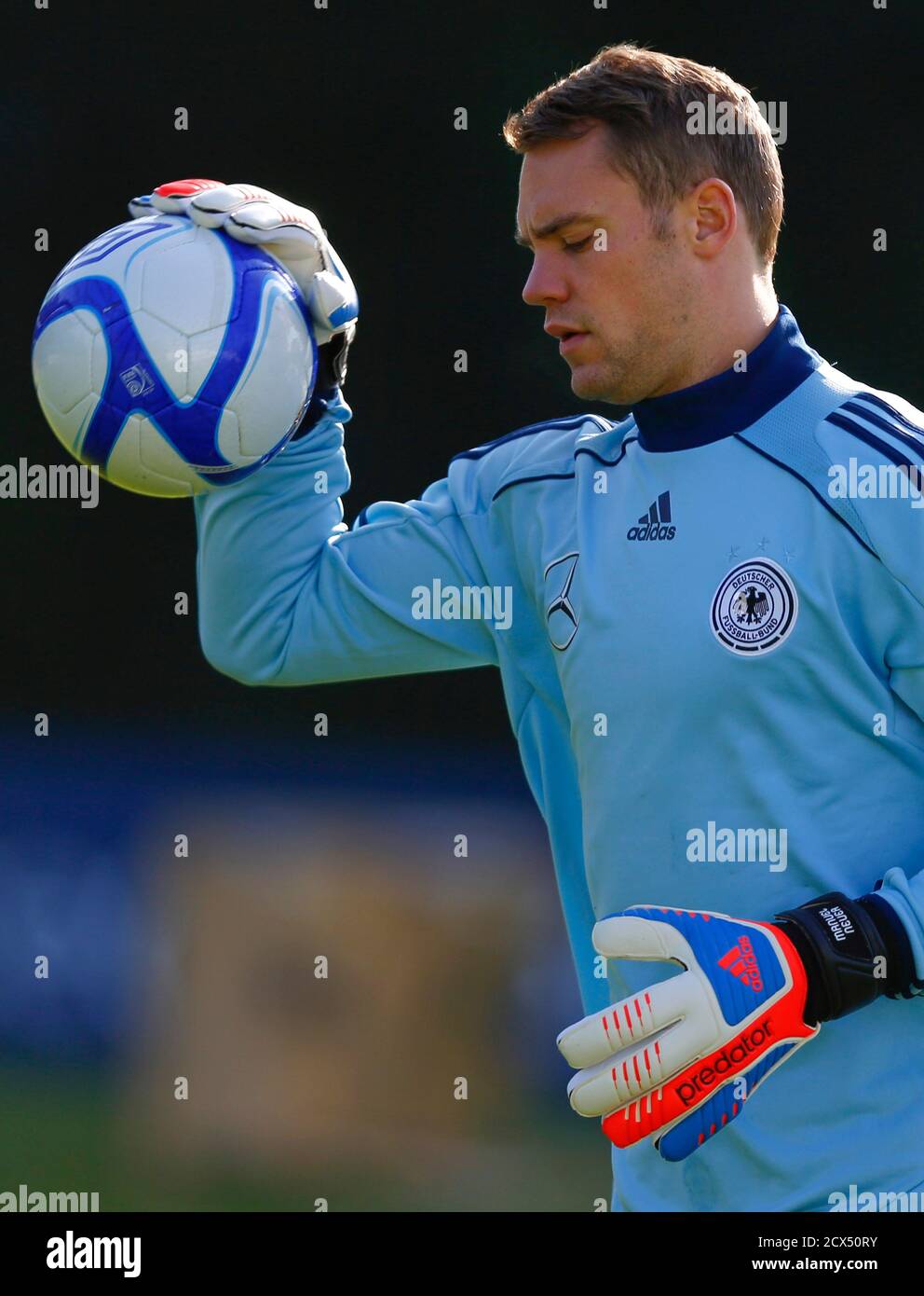 Manuel Neuer, goalkeeper of Germany's national soccer team warms up with  the ball used by the Irish team during a practice session in Frankfurt,  October 10, 2012. Germany will play two World