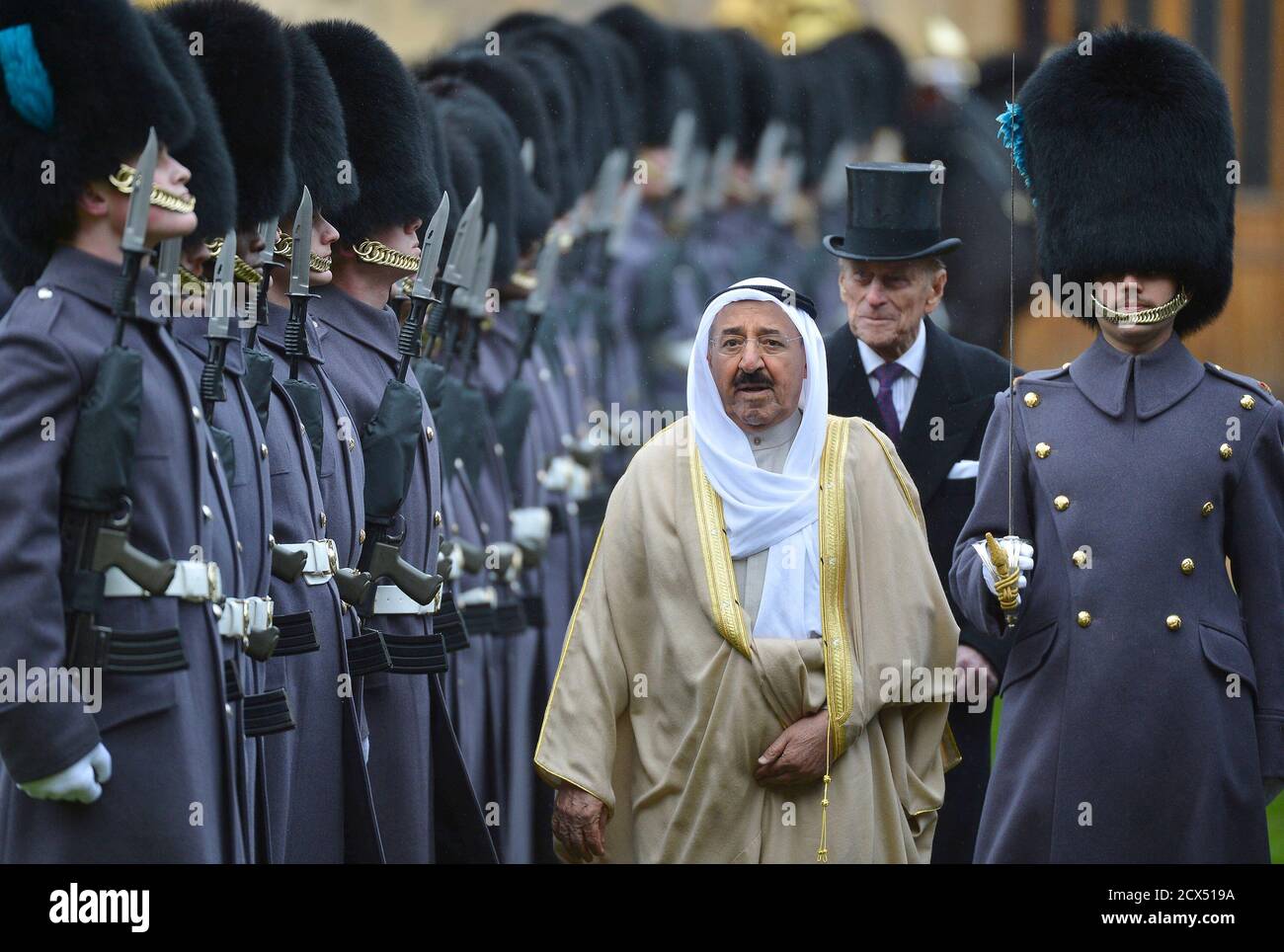 The Emir of Kuwait, Sheikh Sabah al-Ahmad al-Sabah (C), is followed by Britain's Prince Philip (2nd R) as he inspects members of the 1st Battalion Irish Guards at Windsor Castle in Windsor, southern England November 27, 2012. The Emir arrived at Windsor Castle on Tuesday for the start of a state visit to Britain.    REUTERS/Toby Melville (BRITAIN - Tags: ENTERTAINMENT POLITICS SOCIETY ROYALS TPX IMAGES OF THE DAY) Stock Photo