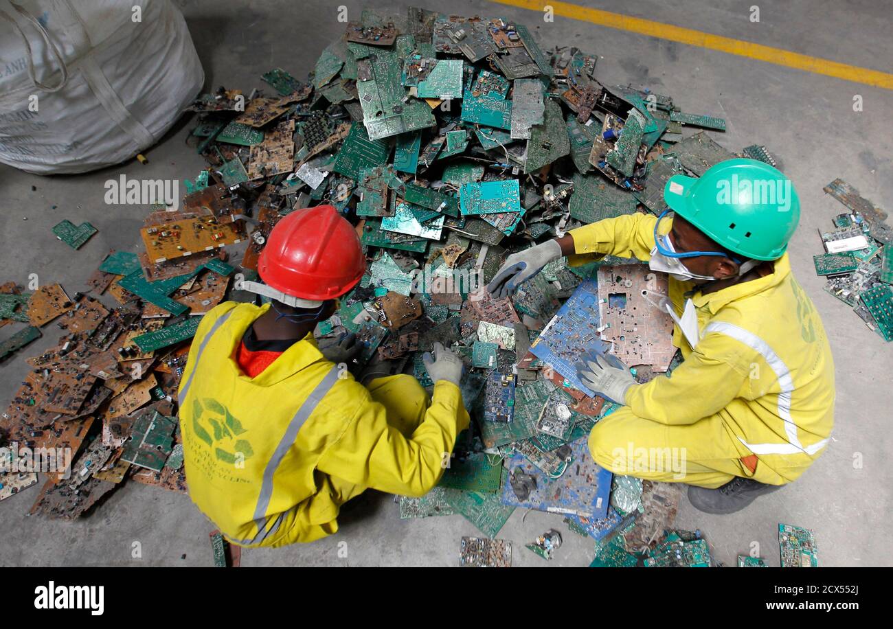 Employee sort out parts of discarded computers and other electronics for  recycling at the East African Compliant Recycling (EACR) facility in Athi  River near Kenya's capital Nairobi, March 7, 2014. The E-waste