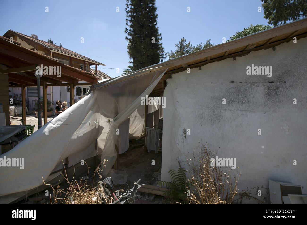 A plastic cover is seen outside a house, that was damaged by a rocket fired from Gaza during the 2014 Gaza war, in Yahud near Tel Aviv, Israel, July 7, 2015. July 8th marks the one-year anniversary of the war between Israel and Hamas in Gaza. The 50-day conflict began after Israel said it was determined to put an end to constant rocket-fire from Gaza, launching an intense air and ground assault to do so. It was the third major conflict between Israel and Hamas militants since the Islamist group seized control of Gaza in 2007. The fighting killed more than 2,100 Palestinians, most of them civil Stock Photo