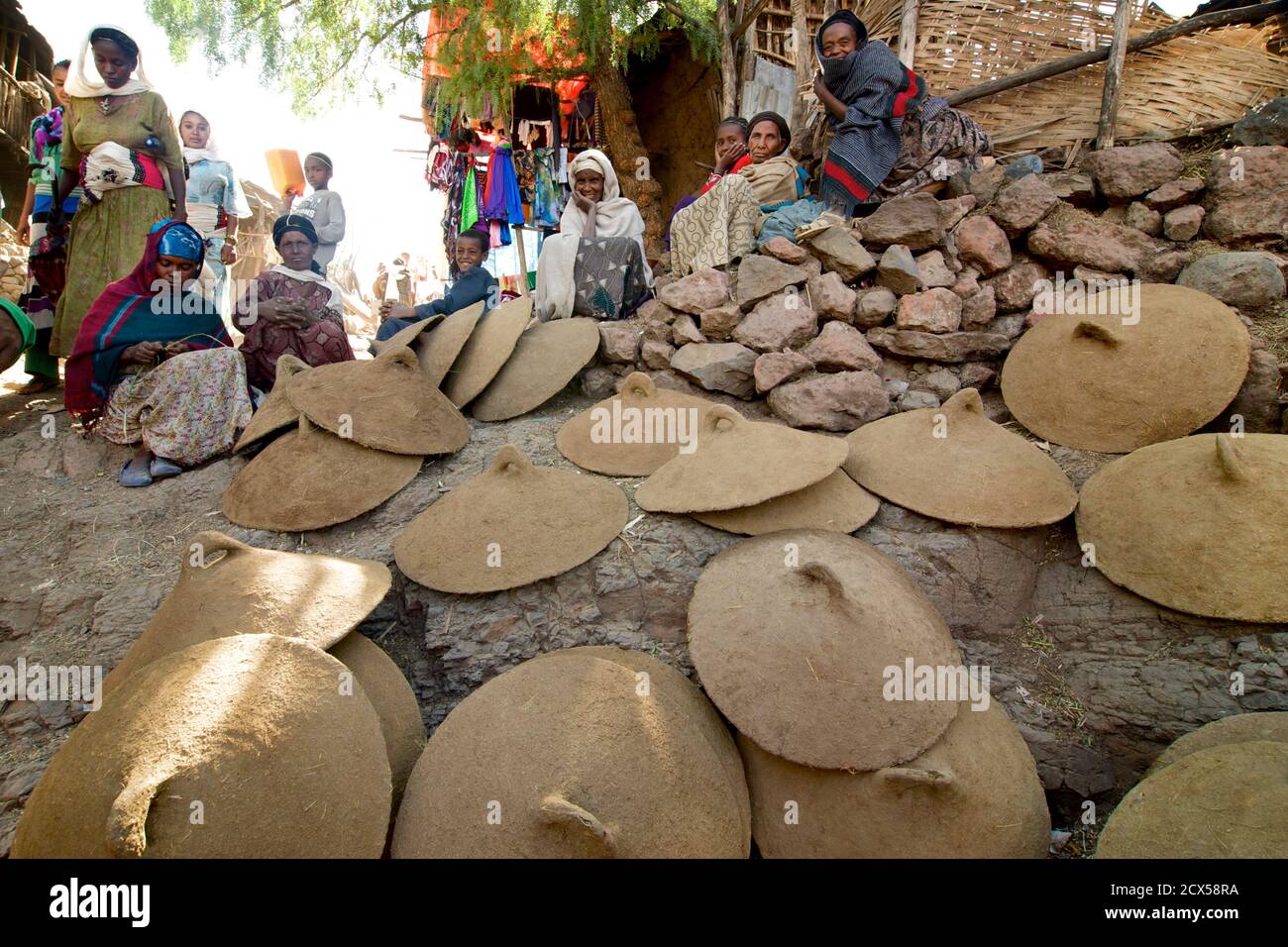 Ethiopian women selling clay injera cooking covers. Market day in Lalibela. Ethiopia Stock Photo