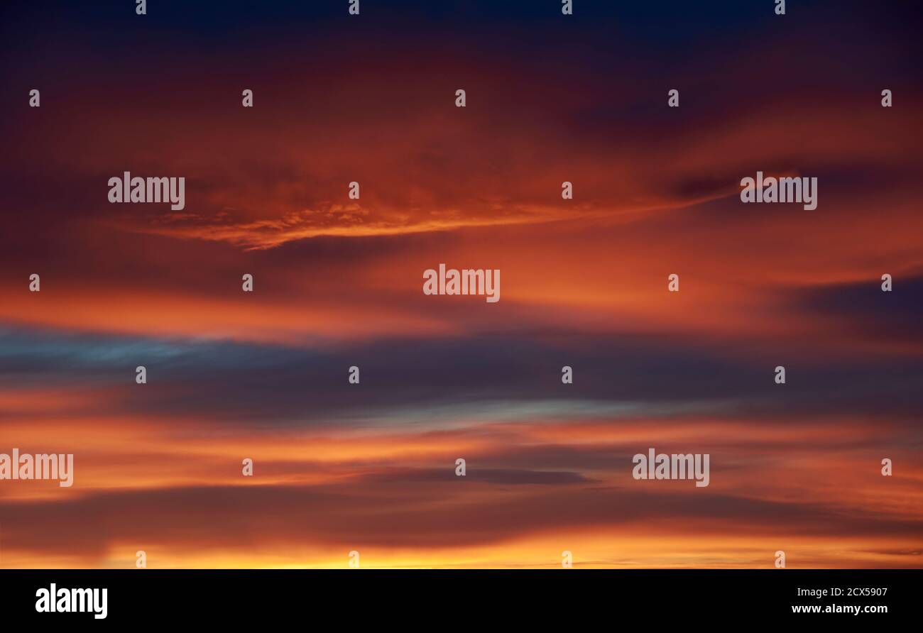 Sunset. Heaven, orange sky. Sun rays. Wallpaper. Clouds Stock Photo - Alamy