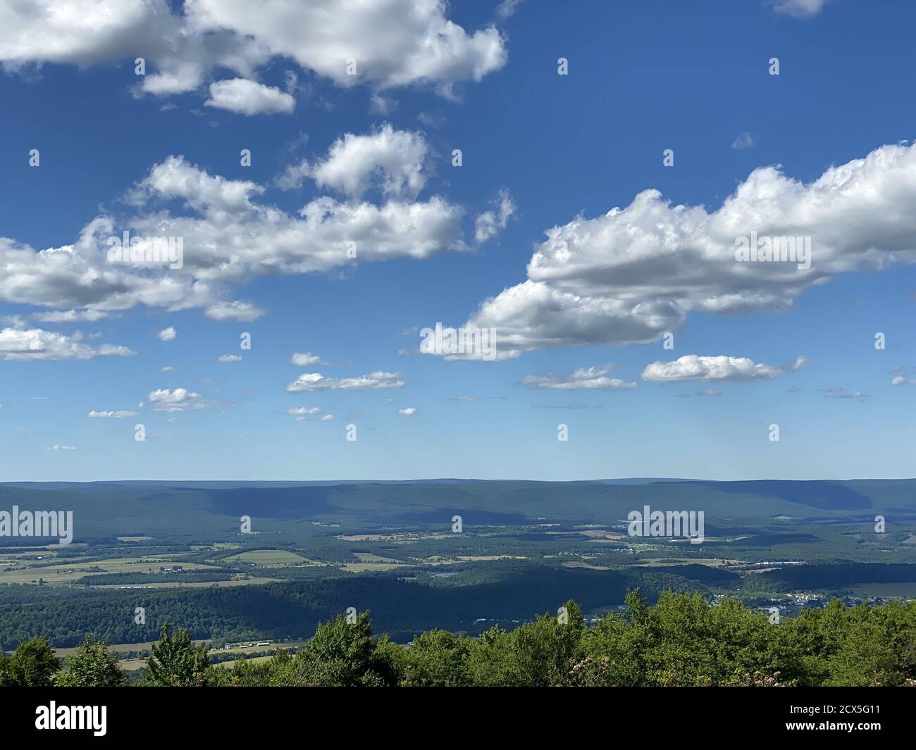 Valley in a rural area under the cloudy sky Stock Photo - Alamy