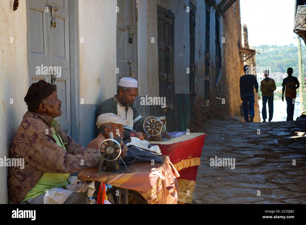 Harari tailors working on their sewing machines in the street. Old town