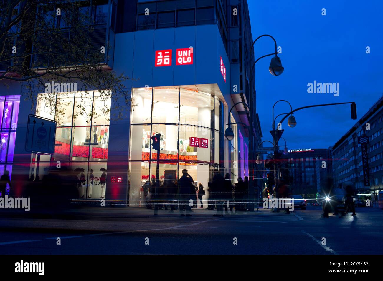 People stand outside of the Uniqlo Global flagship store during a  preopening in Berlin, April 10, 2014. Japanese casual wear chain Uniqlo  opens its first store in Germany on Friday, as it