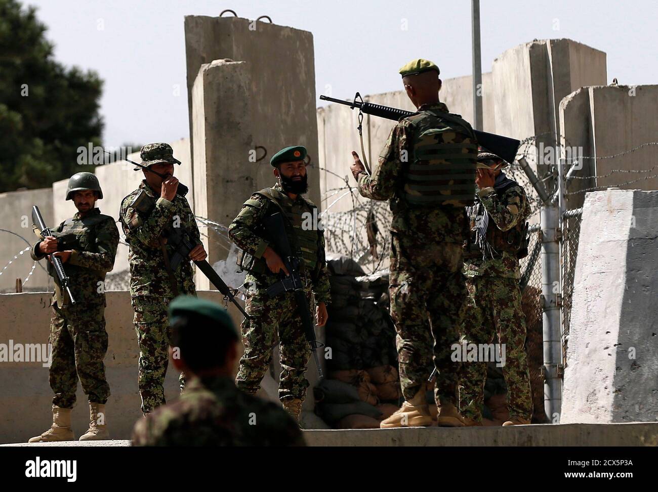 Afghan National Army (ANA) soldiers keep watch at the gate of a British-run  military training academy Camp Qargha, in Kabul August 5, 2014. One  serviceman was killed and 14 wounded, including a
