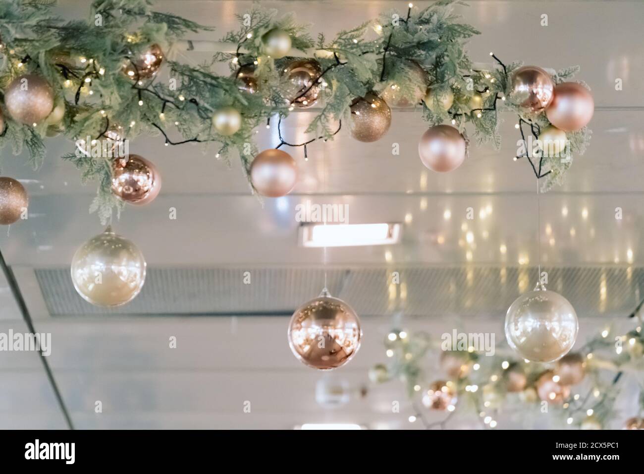 Christmas decorations hanging from ceiling in modern mall, shopping center  or exhibition place. Baubles hanging on branch Stock Photo - Alamy