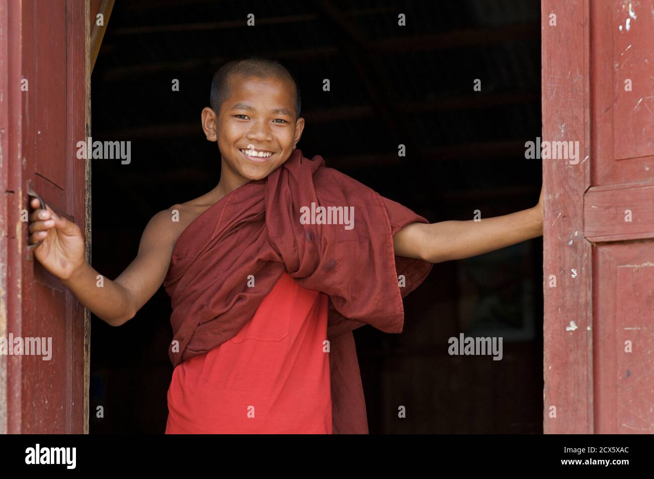 Buddhist monk at window of quarters, Kalaw Monastery, Burma Stock Photo