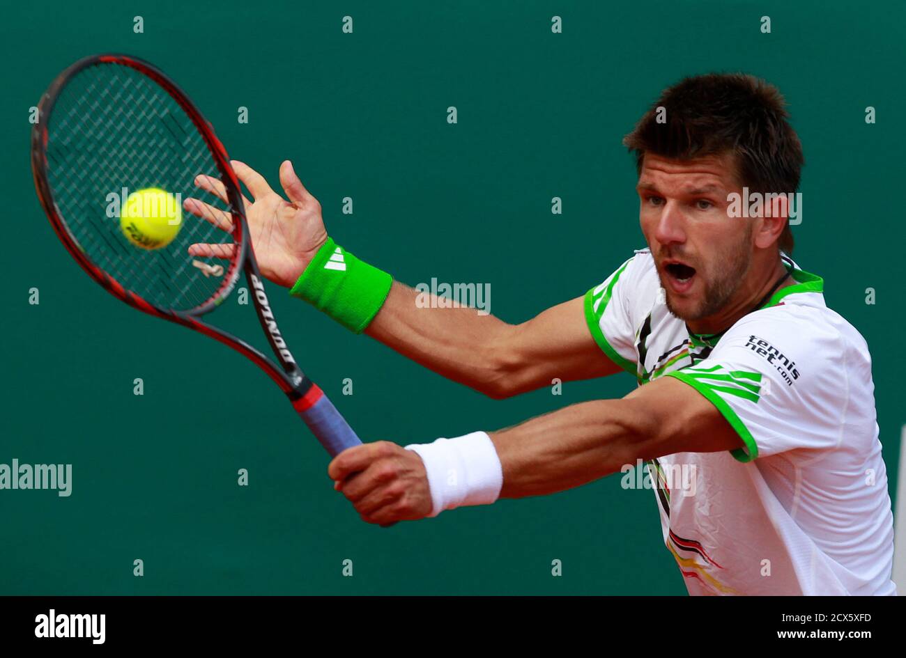 Austria's Jurgen Melzer returns the ball to Switzerland's Roger Federer  during their quarter-final match at the Monte Carlo Masters tennis  tournament in Monaco April 15, 2011. REUTERS/Eric Gaillard (MONACO - Tags:  SPORT