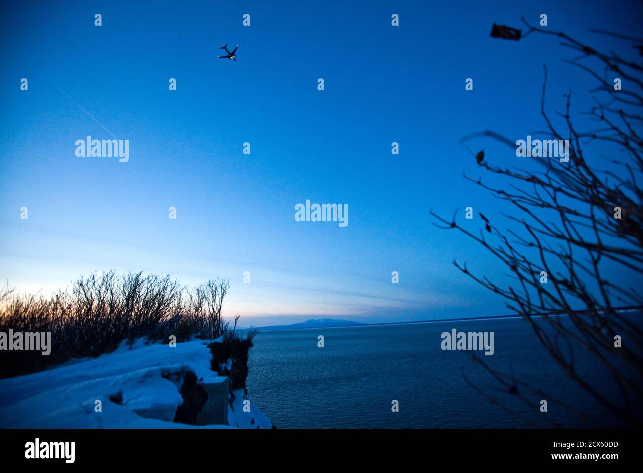 A Passenger Plane Approaches Ted Stevens Anchorage International Airport On A Cold And Clear Day In