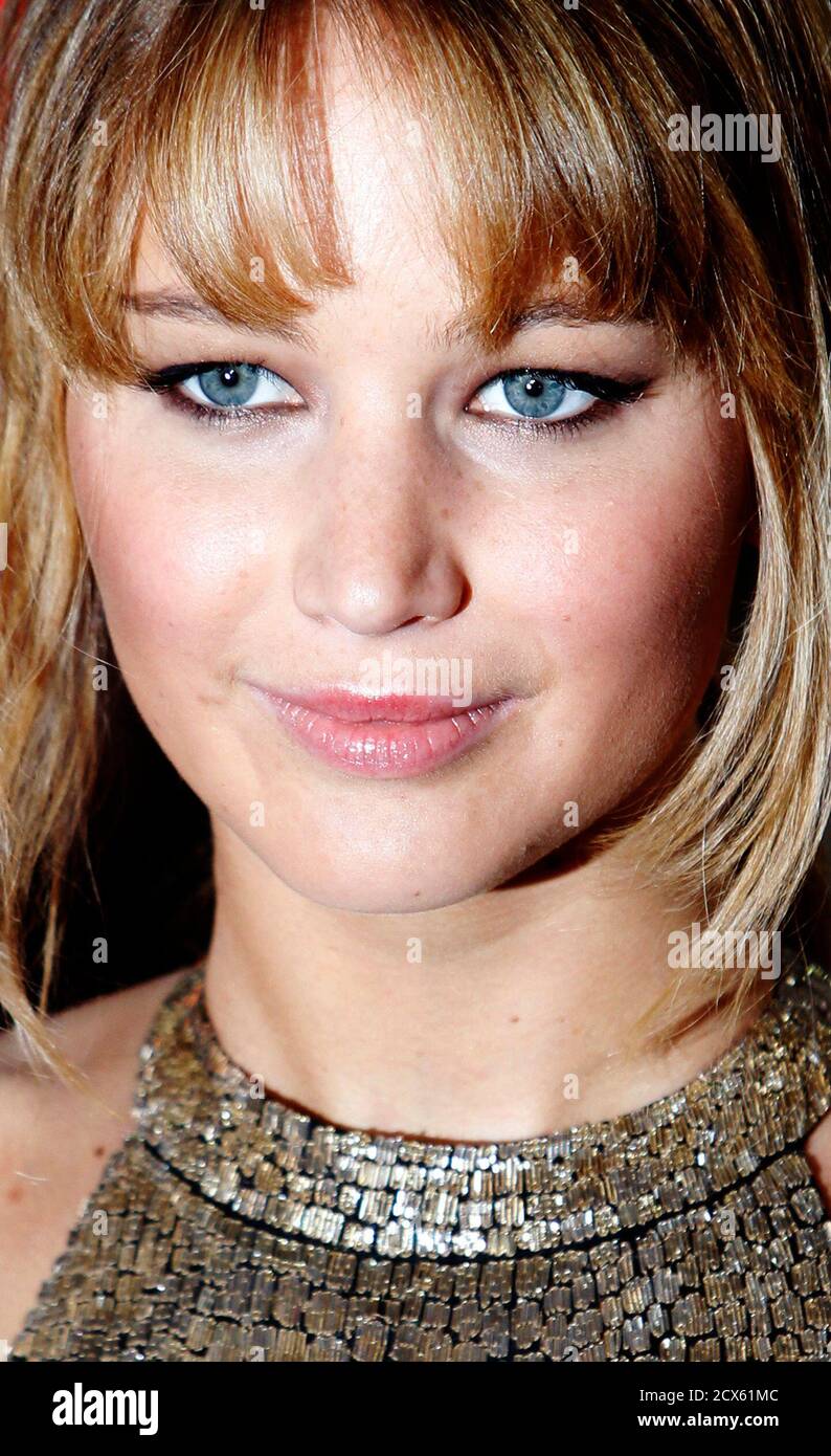 Actress Jennifer Lawrence poses for photographers as she arrives for the  European premiere of "The Hunger Games" at the O2 Arena in London March 14,  2012. REUTERS/Luke MacGregor (BRITAIN - Tags: ENTERTAINMENT